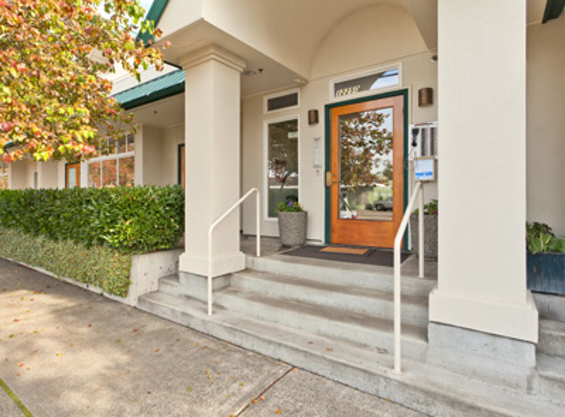 Welcoming columned entrance of a Seattle apartment building managed by Pacific Crest