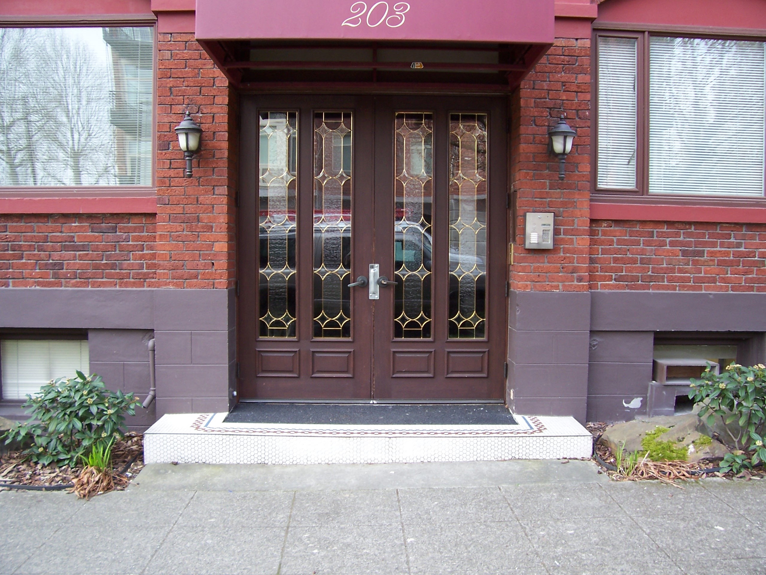Elegant front entrance of a Pacific Crest managed apartment building in Seattle